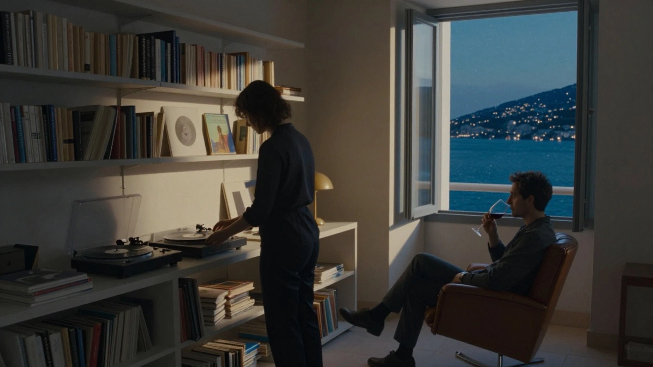 An elegant villa study at night with a woman placing a vinyl record, a man in an armchair, soft lamplight and starlit bay through the window.