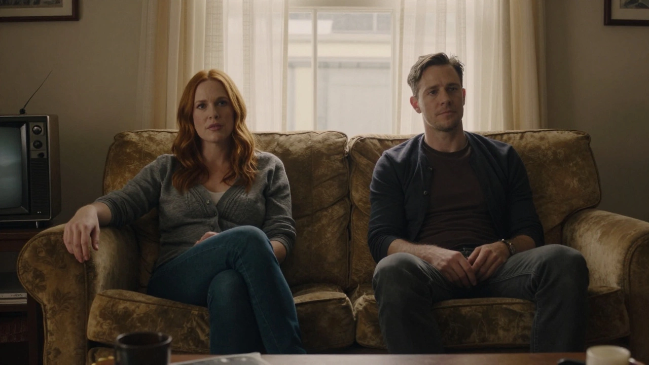 Two people sitting quietly on a couch, watching an old movie together in soft, natural light.