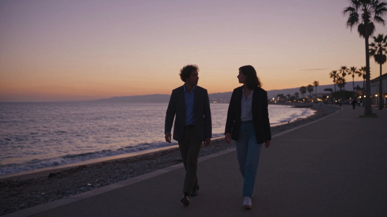 Two people walking quietly along the Promenade des Anglais at dusk, sea and palm trees in the background, calm and intimate mood.